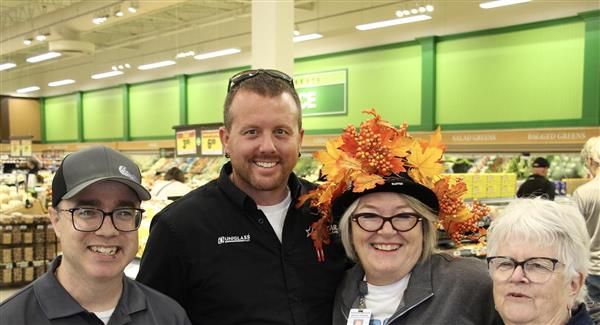 Four people in a grocery store