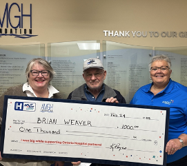 Brian Weaver and two others holding large cheque